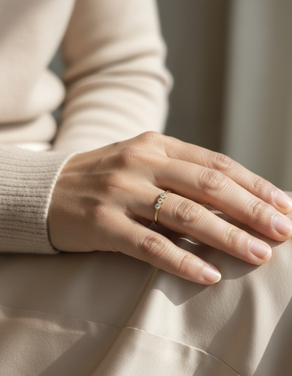 18K yellow gold three-stone natural diamond ring with minimalist bezel setting by Emirates Diamonds