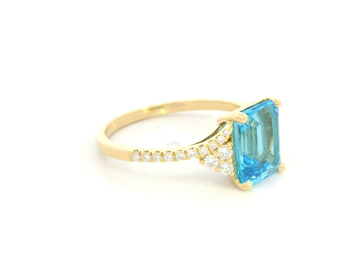Emerald-cut blue topaz and diamond ring in 18K yellow gold by Emirates Diamonds.