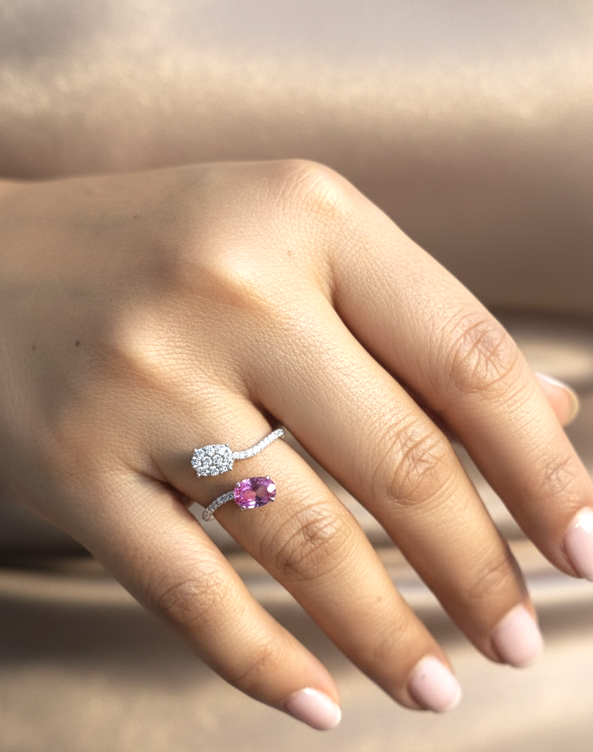 Pink sapphire diamond open wrap ring in 18K white gold with oval pink sapphire and diamond cluster