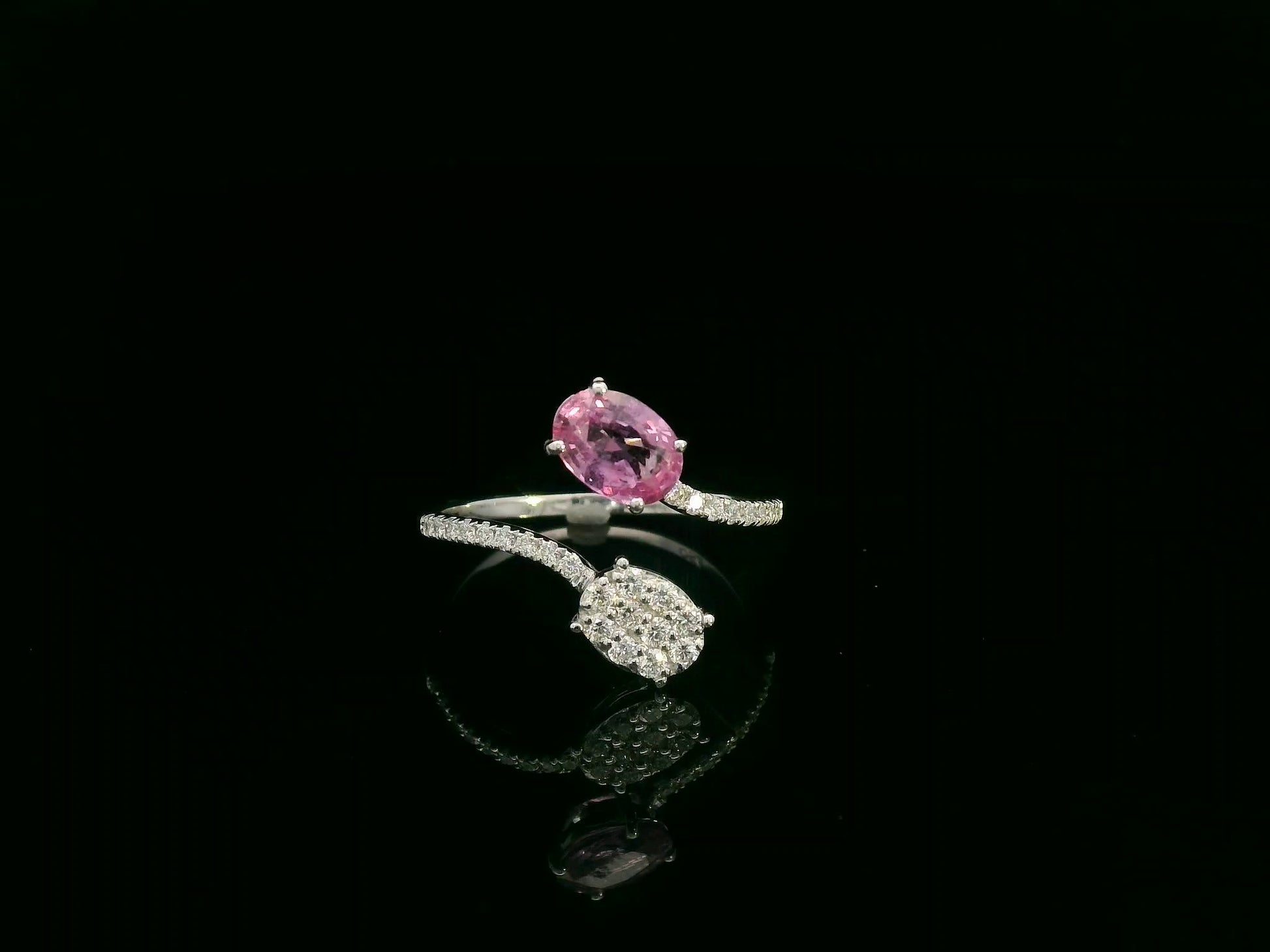 Pink sapphire diamond open wrap ring in 18K white gold with oval pink sapphire and diamond cluster