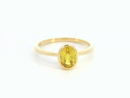 Yellow sapphire solitaire ring in 18K yellow gold featuring a 1.16 carat oval cut gemstone by Emirates Diamonds