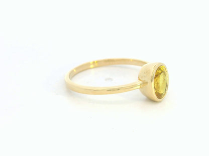 Yellow sapphire solitaire ring in 18K yellow gold featuring a 1.16 carat oval cut gemstone by Emirates Diamonds