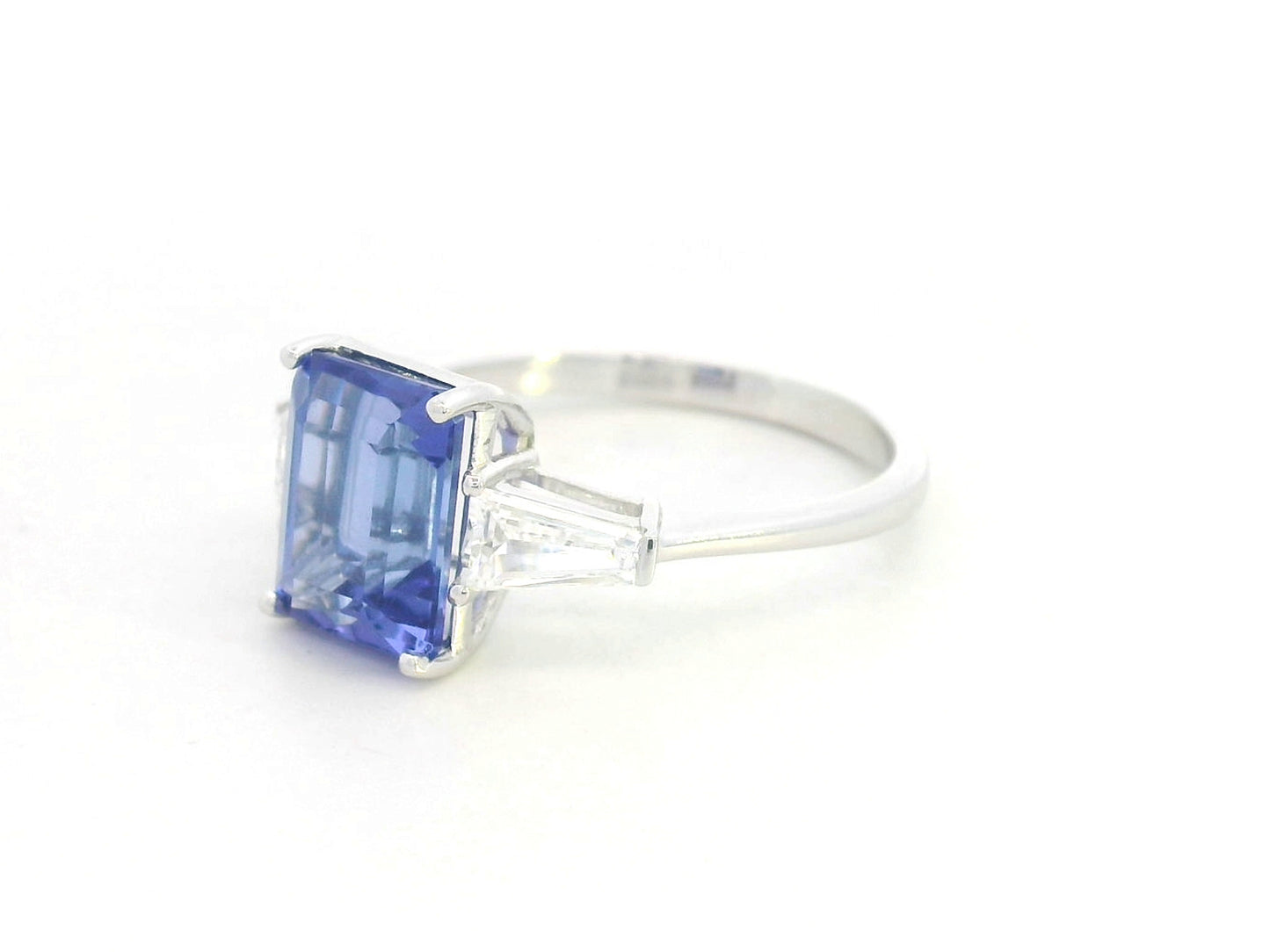 Emerald cut tanzanite and diamond ring in 18K white gold with tapered diamond side stones by Emirates Diamonds