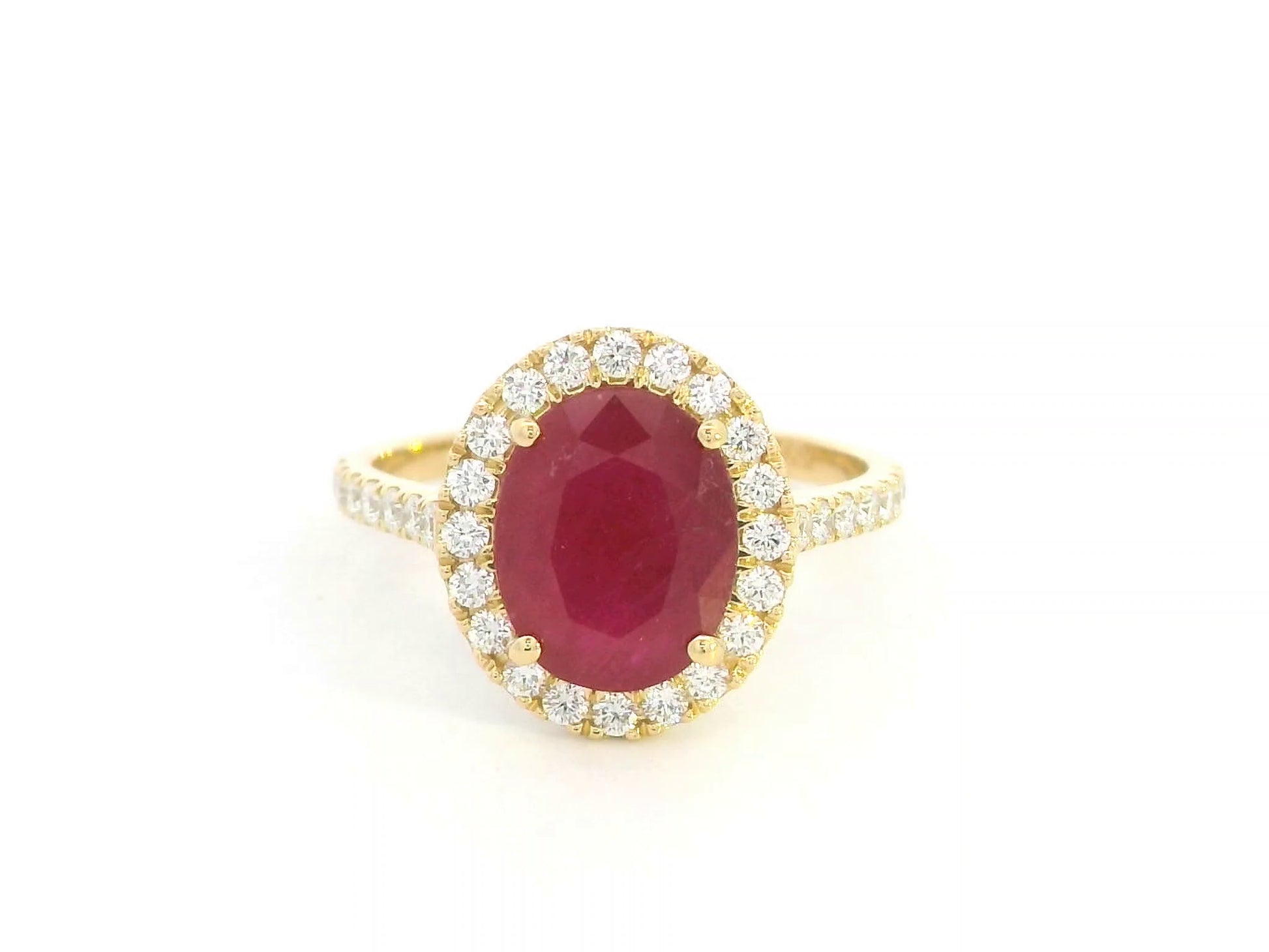 Oval ruby halo ring with diamonds in 18K yellow gold by Emirates Diamonds
