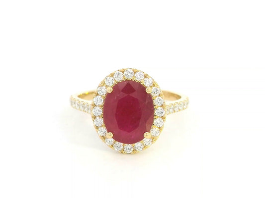 Oval ruby halo ring with diamonds in 18K yellow gold by Emirates Diamonds