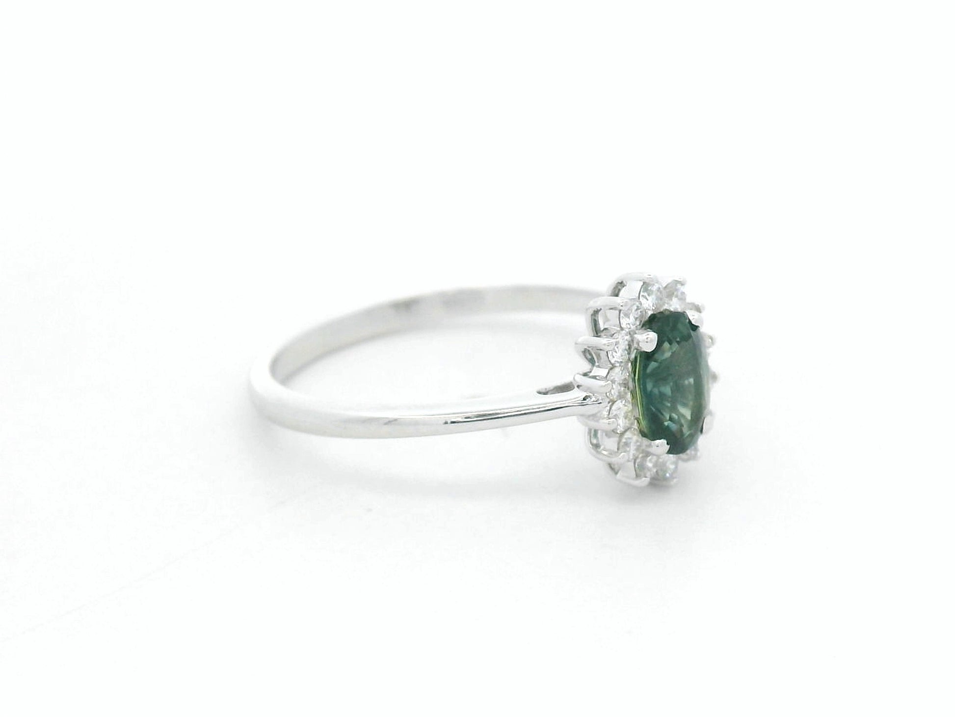 0.74 carat oval green sapphire and diamond halo ring in 18K white gold by Emirates Diamonds
