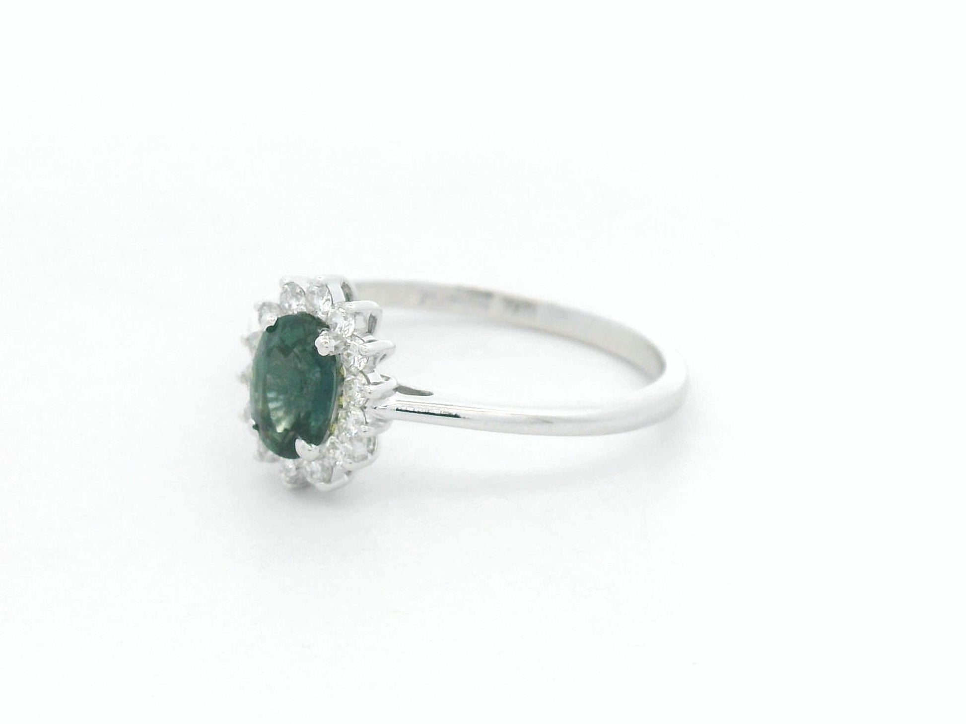0.74 carat oval green sapphire and diamond halo ring in 18K white gold by Emirates Diamonds