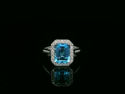 18K white gold Swiss blue topaz ring with diamond halo – emerald cut 2.35 carat topaz fine jewelry by Emirates Diamonds
