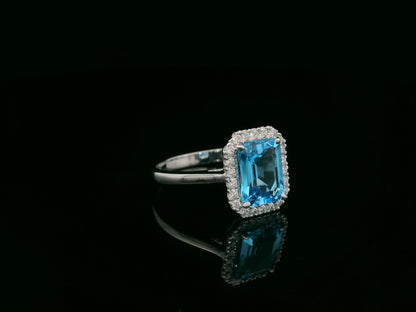 18K white gold Swiss blue topaz ring with diamond halo – emerald cut 2.35 carat topaz fine jewelry by Emirates Diamonds