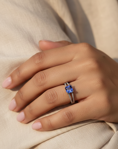 18K white gold split shank ring featuring 0.78 carat square-cut tanzanite and 0.16 carat diamond pavé band by Emirates Diamonds.