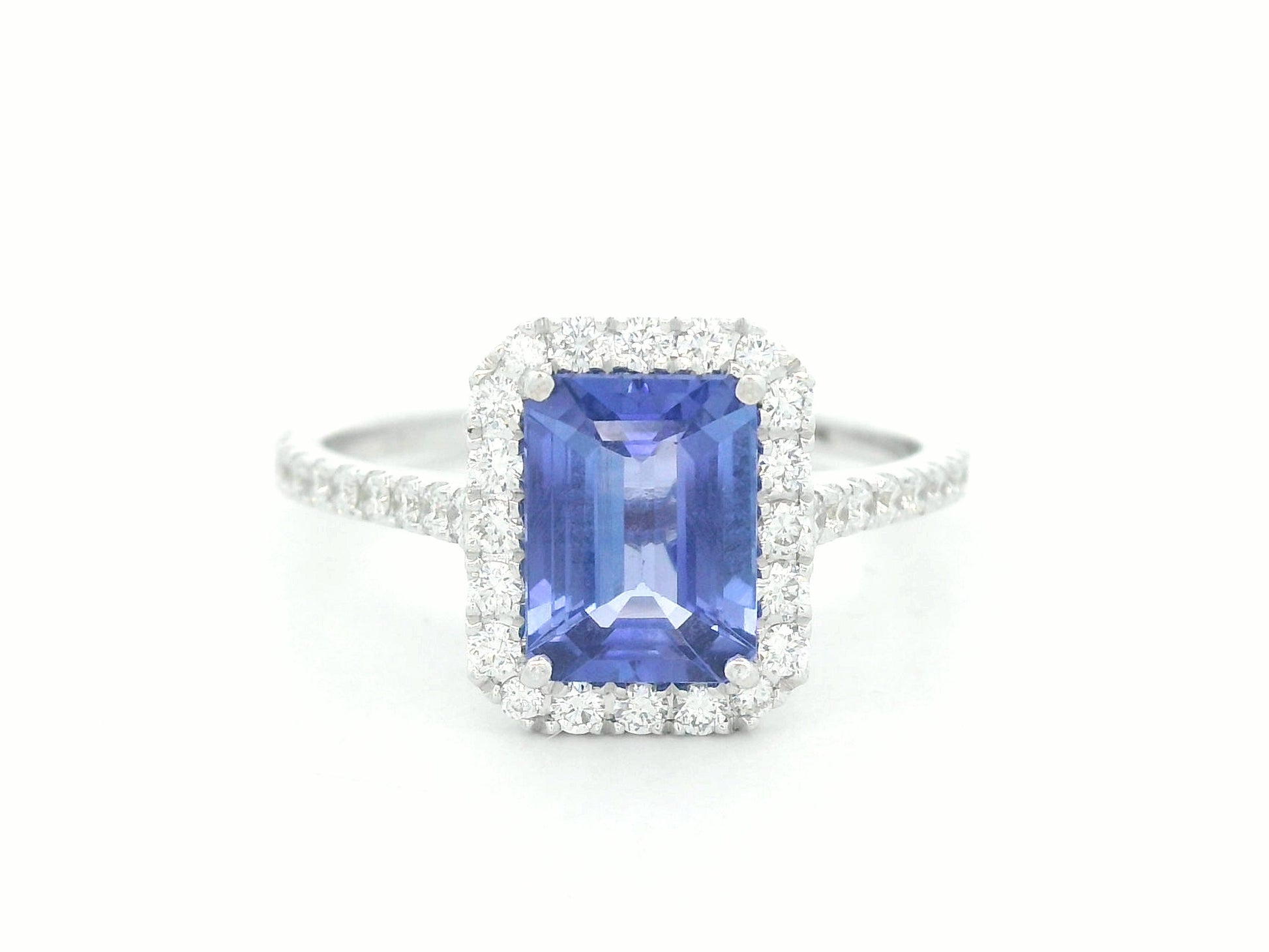 18K white gold tanzanite and diamond bridal ring set with halo engagement ring and diamond wedding band by Emirates Diamonds