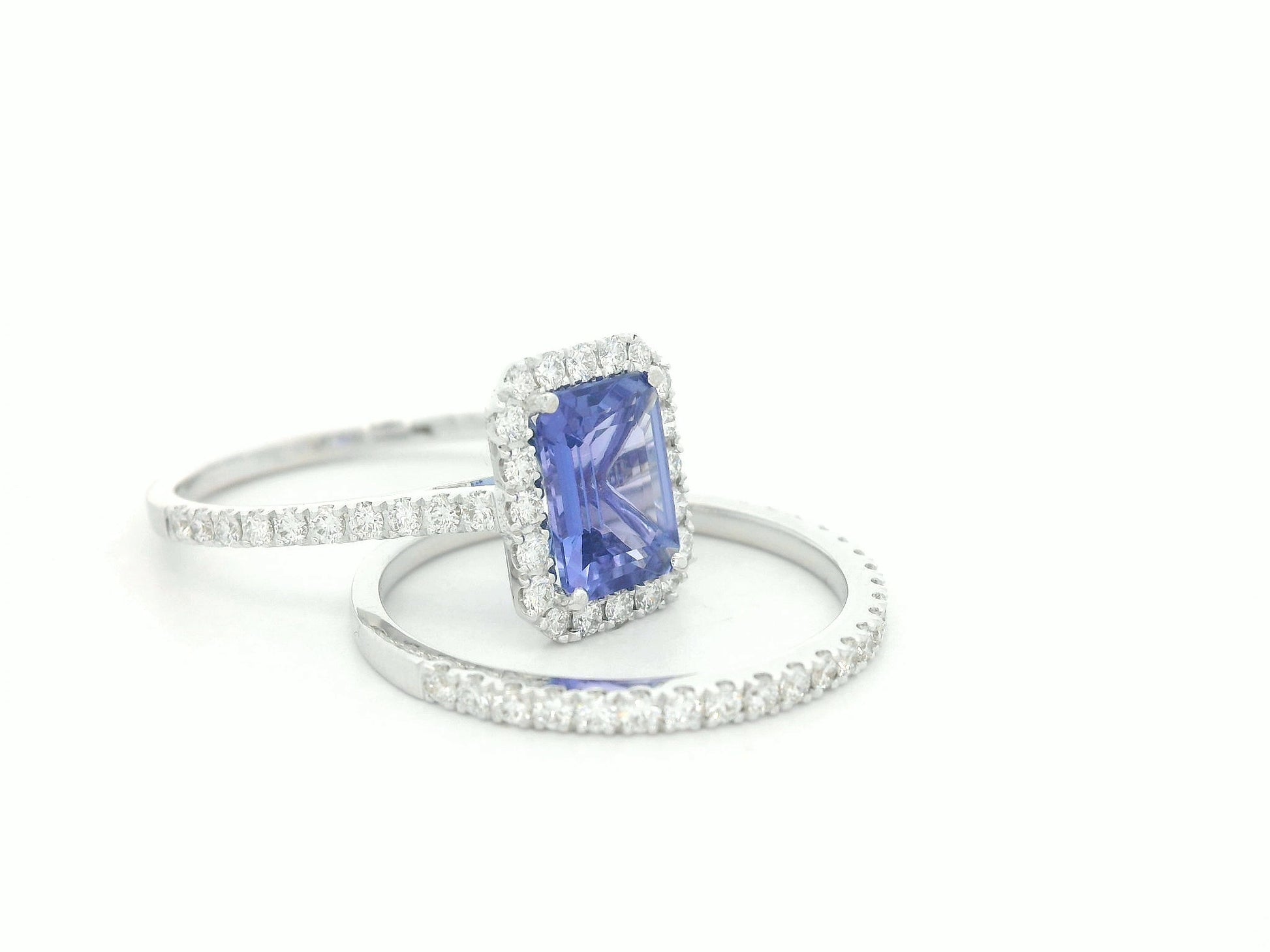 18K white gold tanzanite and diamond bridal ring set with halo engagement ring and diamond wedding band by Emirates Diamonds