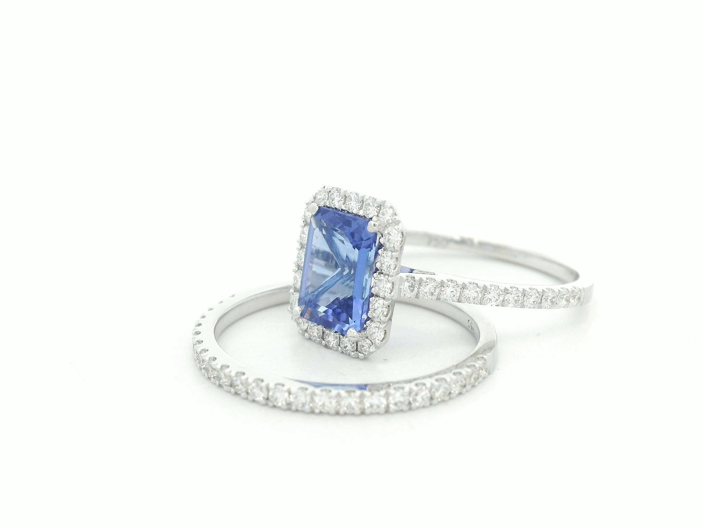 18K white gold tanzanite and diamond bridal ring set with halo engagement ring and diamond wedding band by Emirates Diamonds
