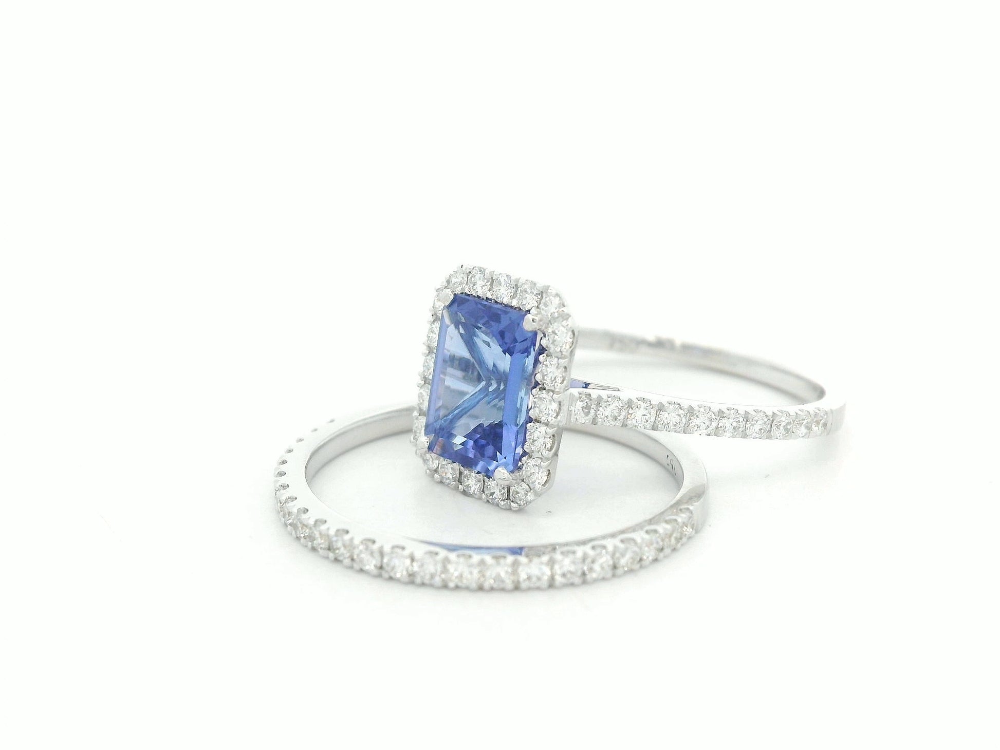 18K white gold tanzanite and diamond bridal ring set with halo engagement ring and diamond wedding band by Emirates Diamonds