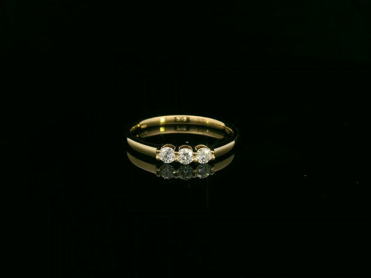 18K yellow gold diamond three-stone ring with round brilliant diamonds, classic trilogy ring design by Emirates Diamonds