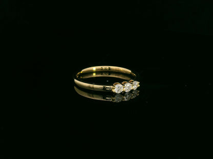 18K yellow gold diamond three-stone ring with round brilliant diamonds, classic trilogy ring design by Emirates Diamonds