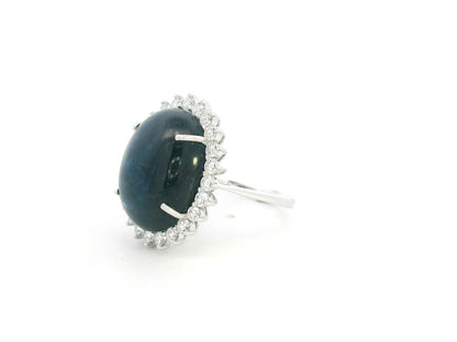 18K white gold oval blue sapphire ring with diamond halo, high-carat sapphire statement ring by Emirates Diamonds