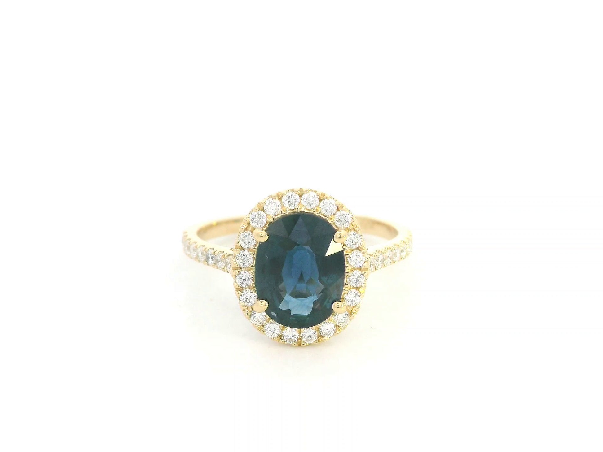 18K yellow gold blue sapphire and diamond halo ring with oval sapphire centerpiece by Emirates Diamonds