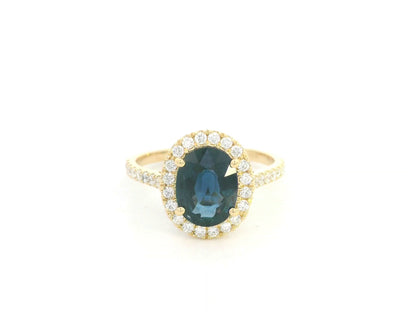 18K yellow gold blue sapphire and diamond halo ring with oval sapphire centerpiece by Emirates Diamonds