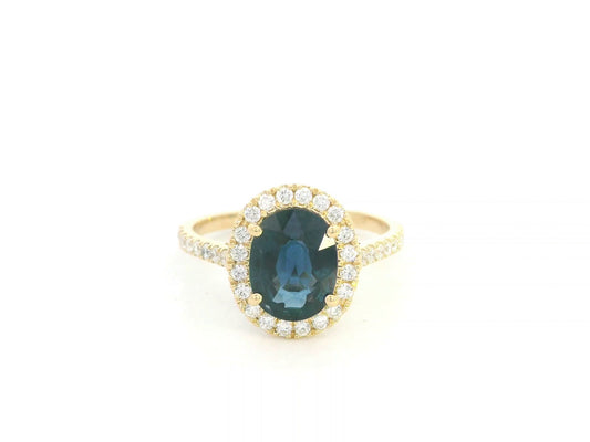 18K yellow gold blue sapphire and diamond halo ring with oval sapphire centerpiece by Emirates Diamonds