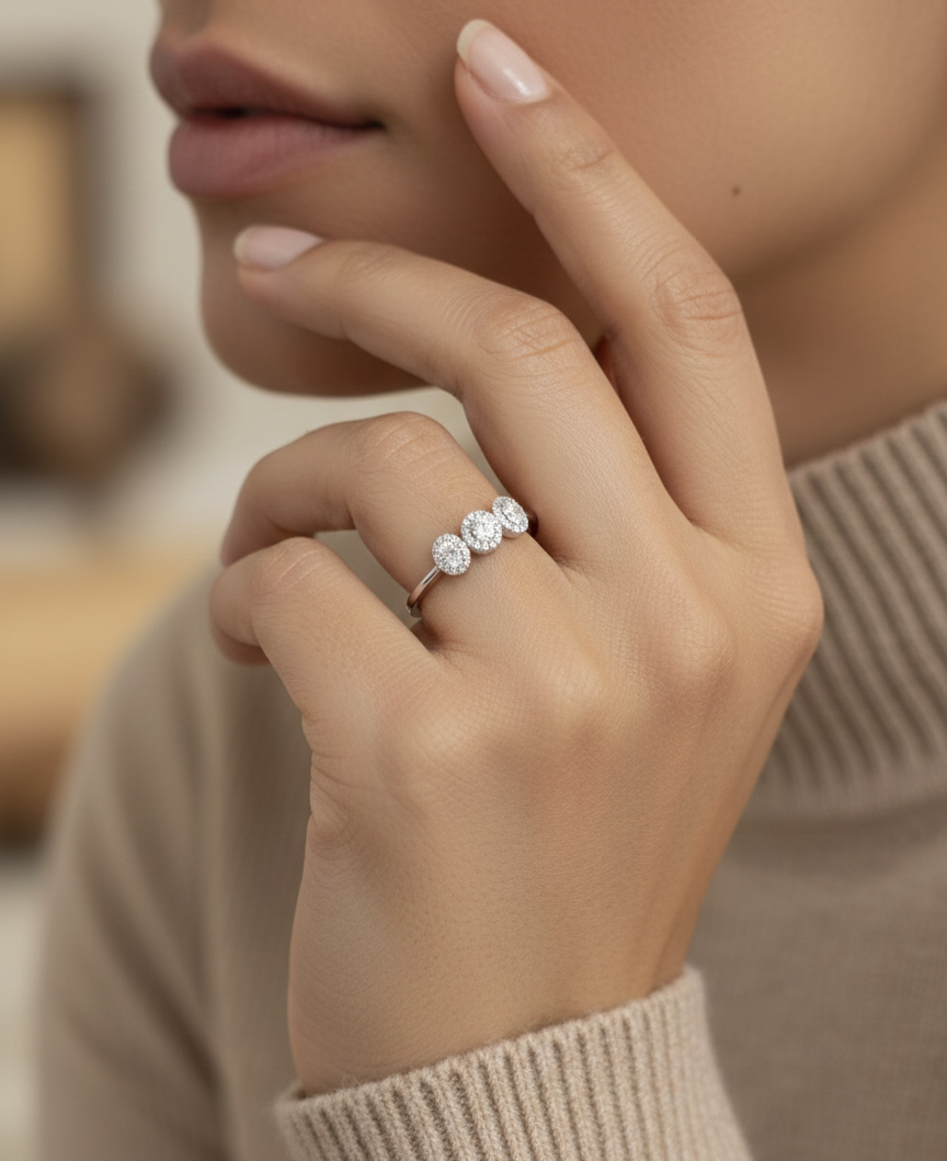 Diamond trilogy halo ring in 18K white gold with three round diamond clusters