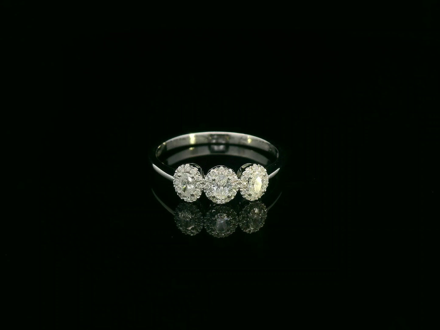 Diamond trilogy halo ring in 18K white gold with three round diamond clusters
