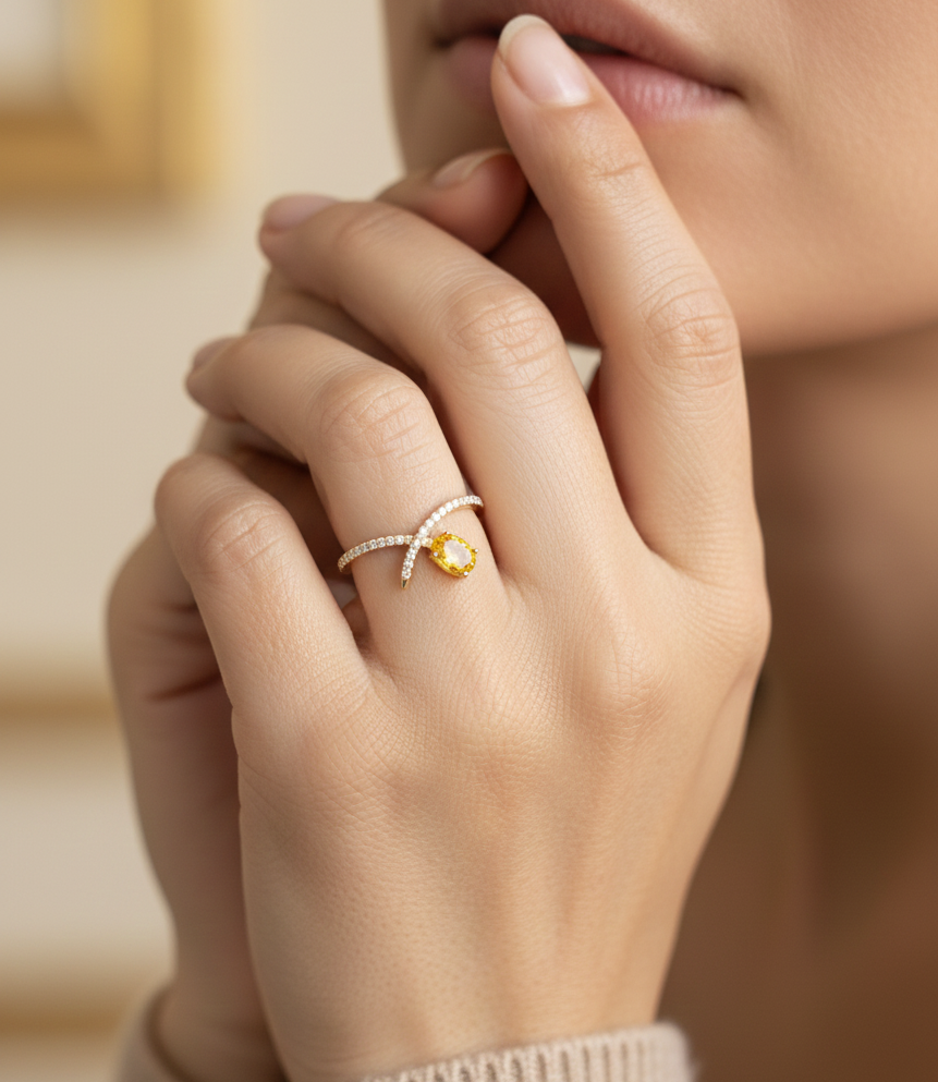 18K yellow gold oval yellow sapphire and diamond bypass statement ring by Emirates Diamonds