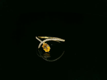 18K yellow gold oval yellow sapphire and diamond bypass statement ring by Emirates Diamonds