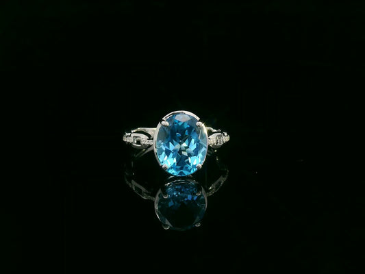 18K white gold oval Swiss blue topaz ring with diamond accents by Emirates Diamonds