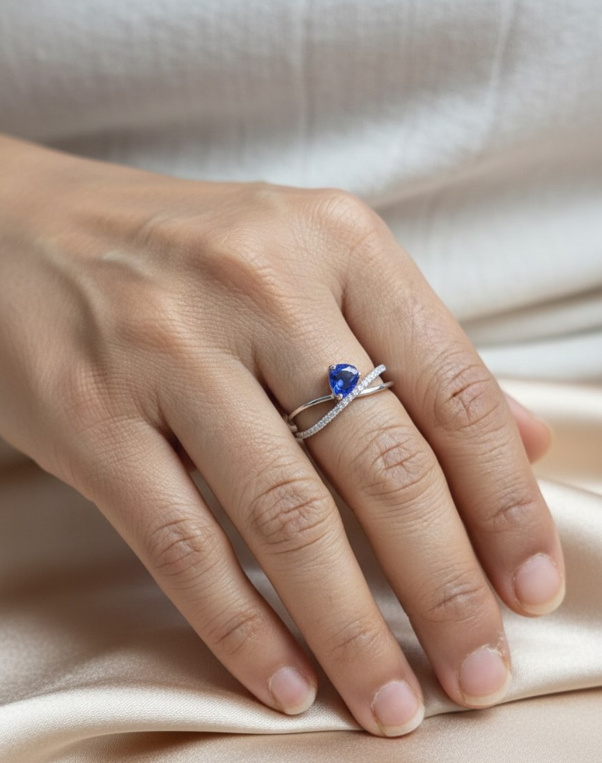 1.01 carat pear shaped blue sapphire and diamond crossover ring in 18K white gold by Emirates Diamonds