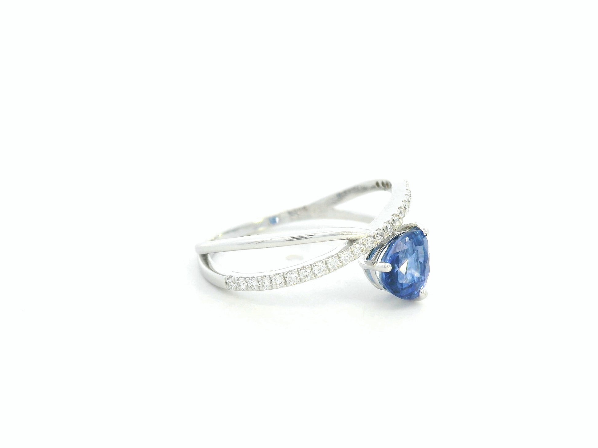 1.01 carat pear shaped blue sapphire and diamond crossover ring in 18K white gold by Emirates Diamonds