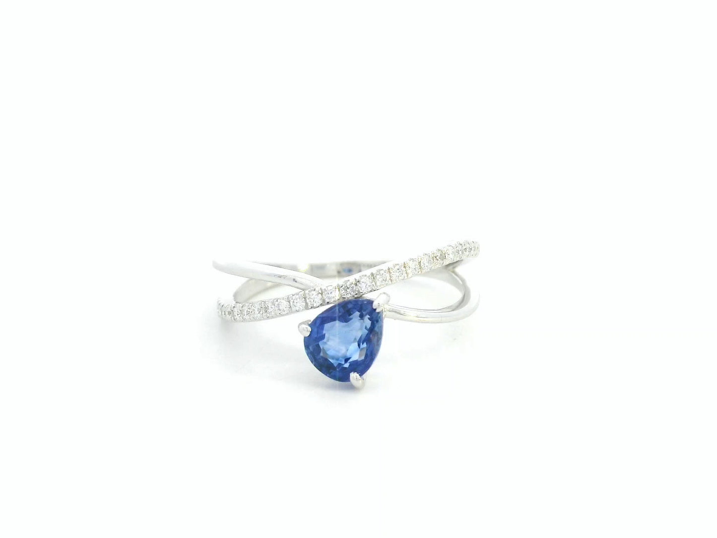 1.01 carat pear shaped blue sapphire and diamond crossover ring in 18K white gold by Emirates Diamonds