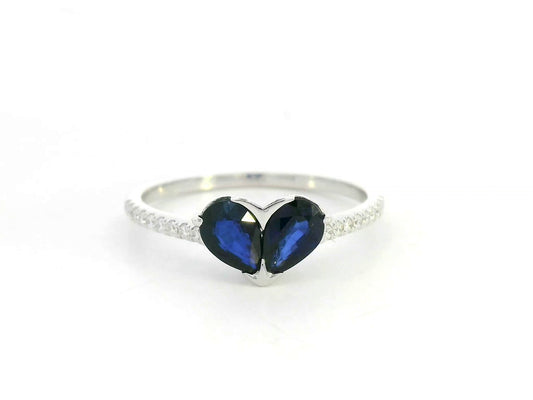 18K white gold  heart ring featuring two blue sapphires totaling 1.08 carat with 0.10 carat diamond accents by Emirates Diamonds.