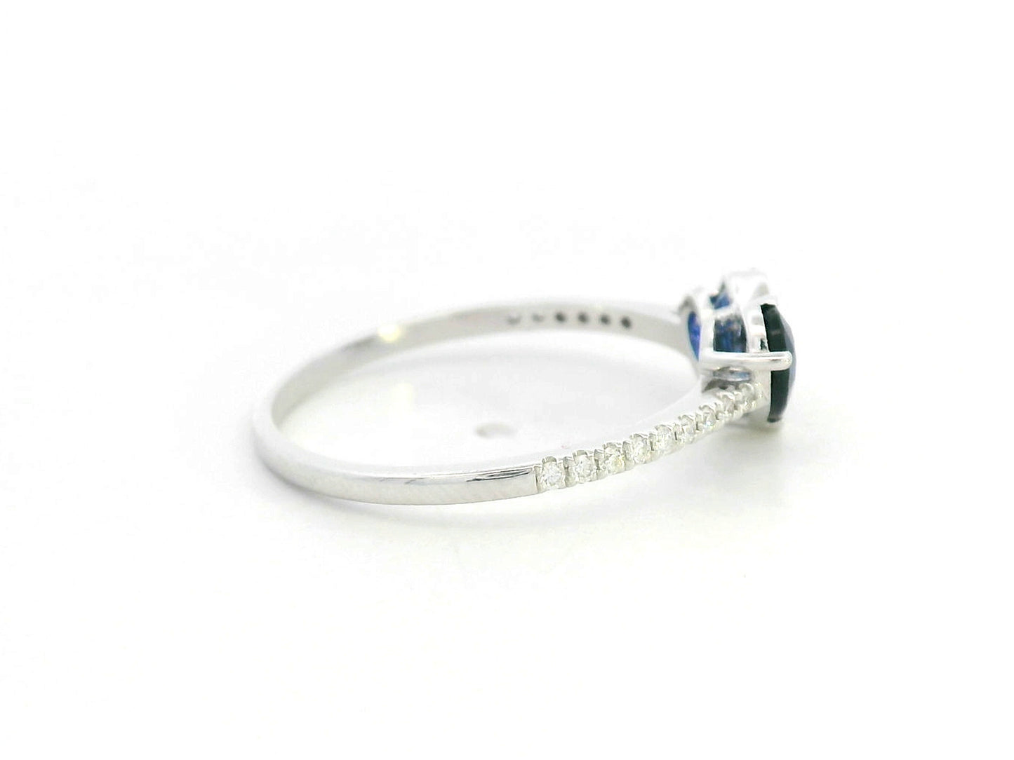 18K white gold  heart ring featuring two blue sapphires totaling 1.08 carat with 0.10 carat diamond accents by Emirates Diamonds.