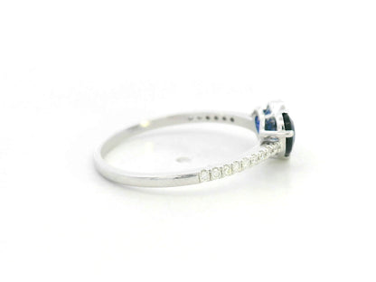 18K white gold  heart ring featuring two blue sapphires totaling 1.08 carat with 0.10 carat diamond accents by Emirates Diamonds.