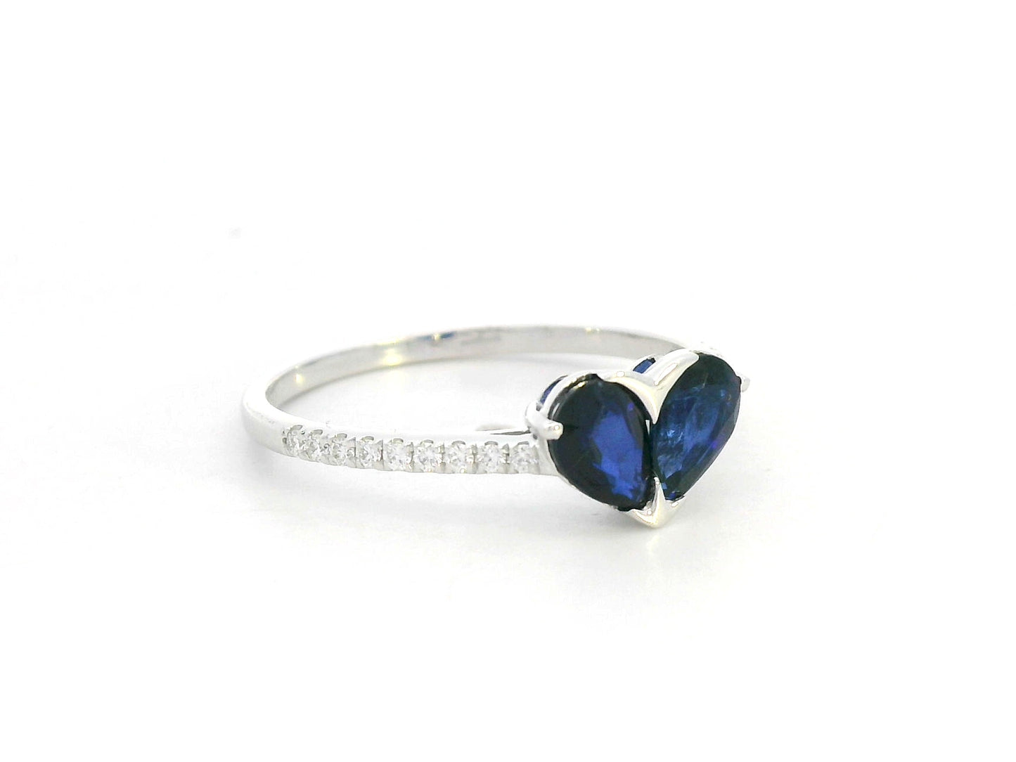 18K white gold  heart ring featuring two blue sapphires totaling 1.08 carat with 0.10 carat diamond accents by Emirates Diamonds.