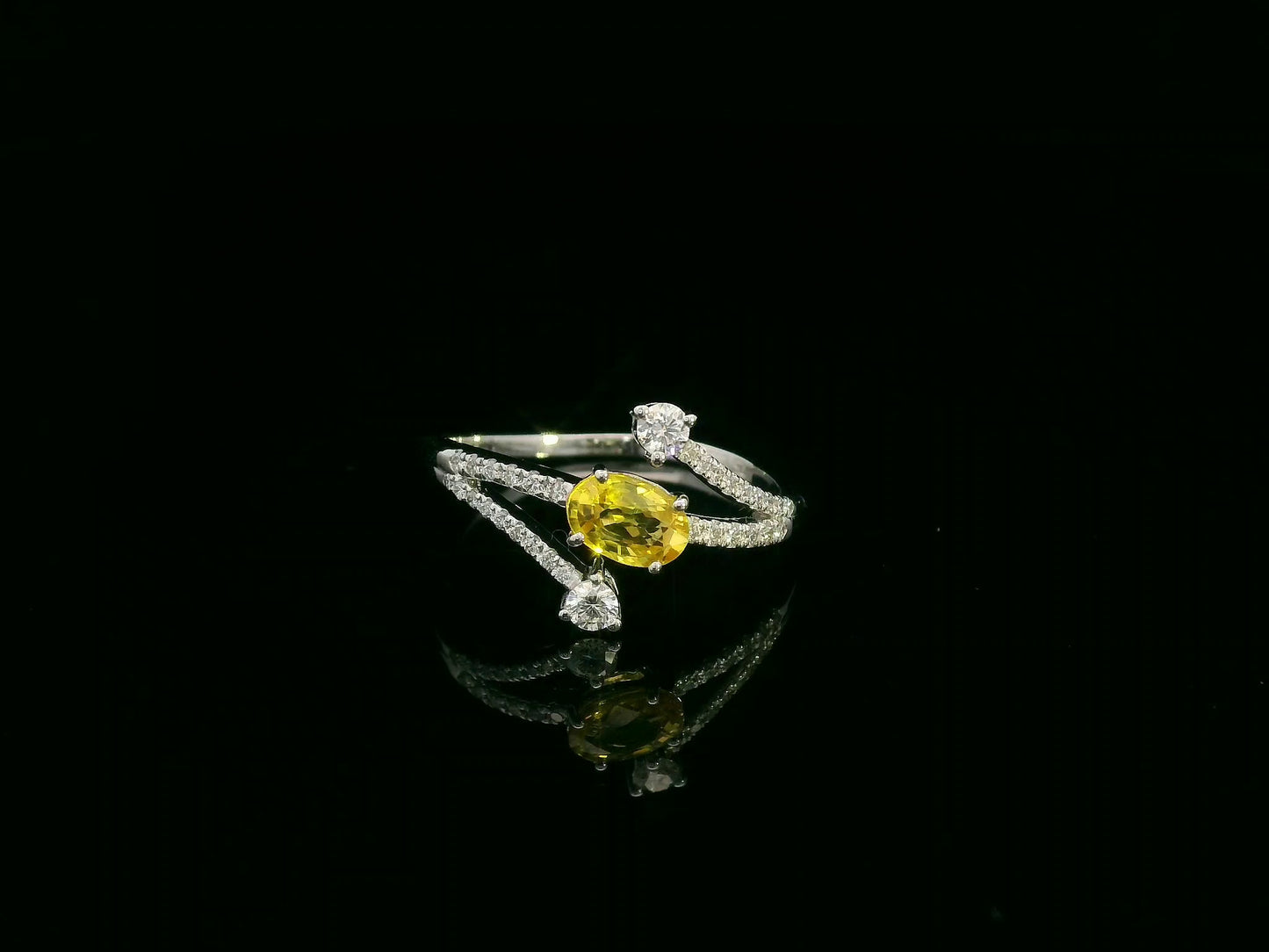 18K white gold ring featuring 0.68 carat oval yellow sapphire with 0.26 carat diamond split band design by Emirates Diamonds.