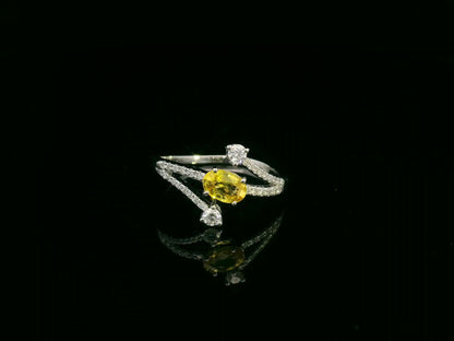 18K white gold ring featuring 0.68 carat oval yellow sapphire with 0.26 carat diamond split band design by Emirates Diamonds.