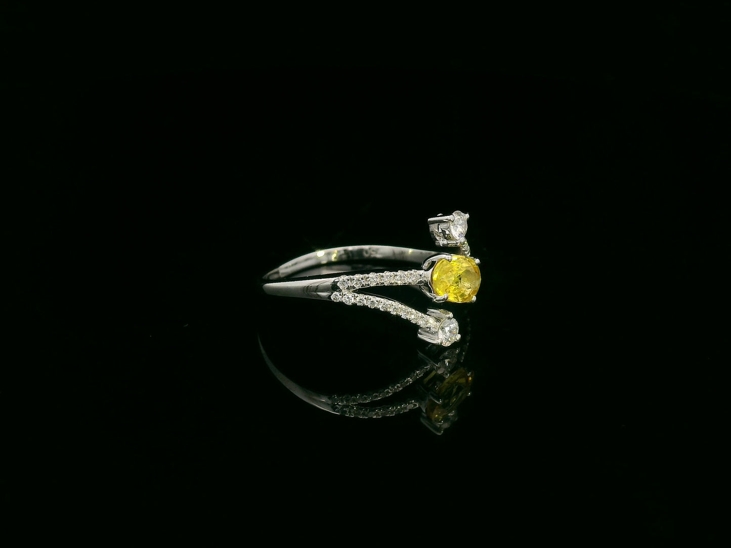 18K white gold ring featuring 0.68 carat oval yellow sapphire with 0.26 carat diamond split band design by Emirates Diamonds.