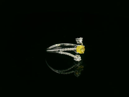 18K white gold ring featuring 0.68 carat oval yellow sapphire with 0.26 carat diamond split band design by Emirates Diamonds.