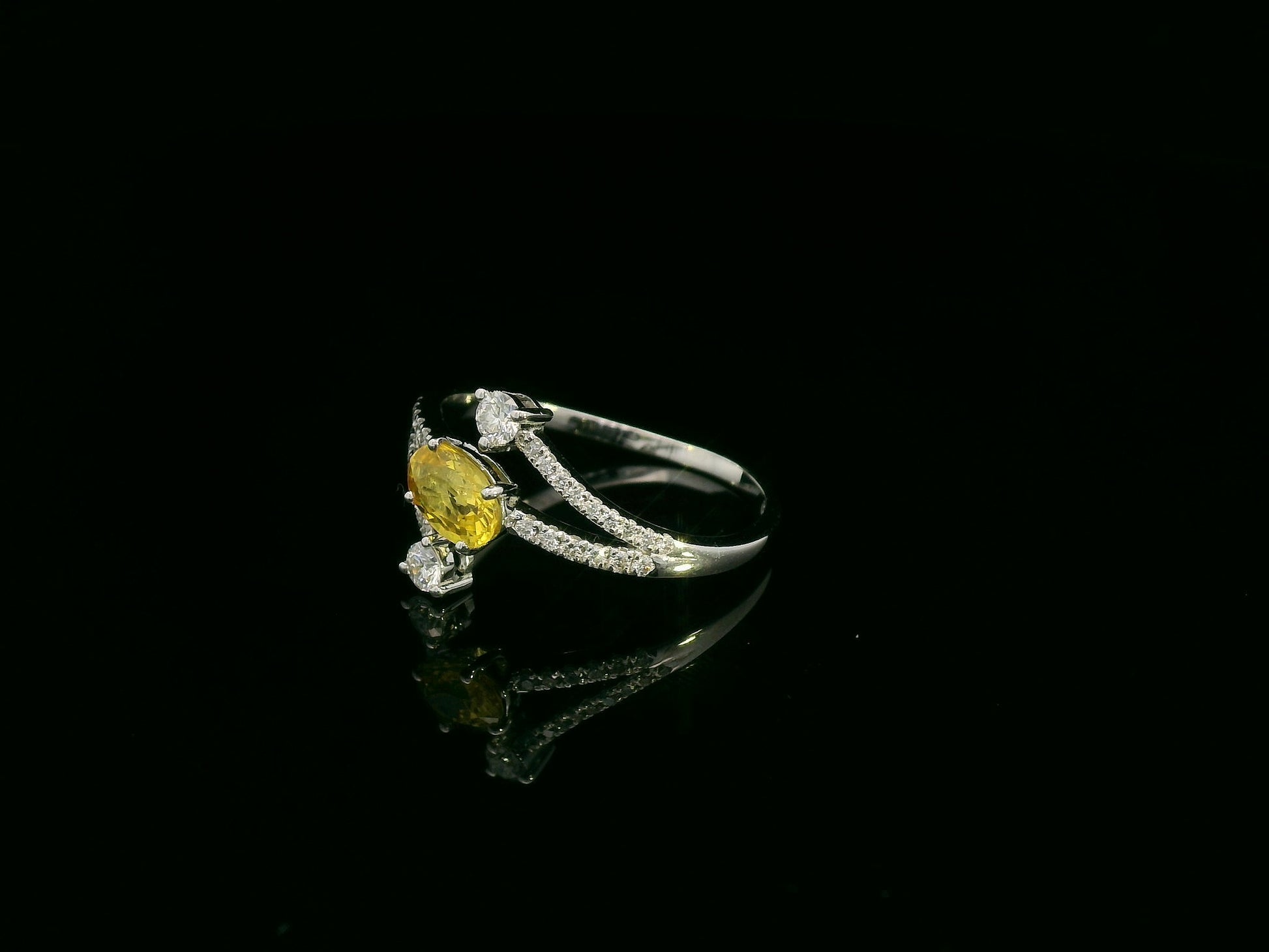 18K white gold ring featuring 0.68 carat oval yellow sapphire with 0.26 carat diamond split band design by Emirates Diamonds.