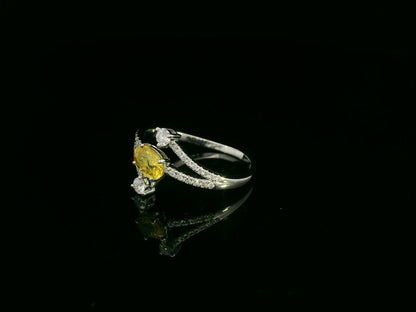 18K white gold ring featuring 0.68 carat oval yellow sapphire with 0.26 carat diamond split band design by Emirates Diamonds.