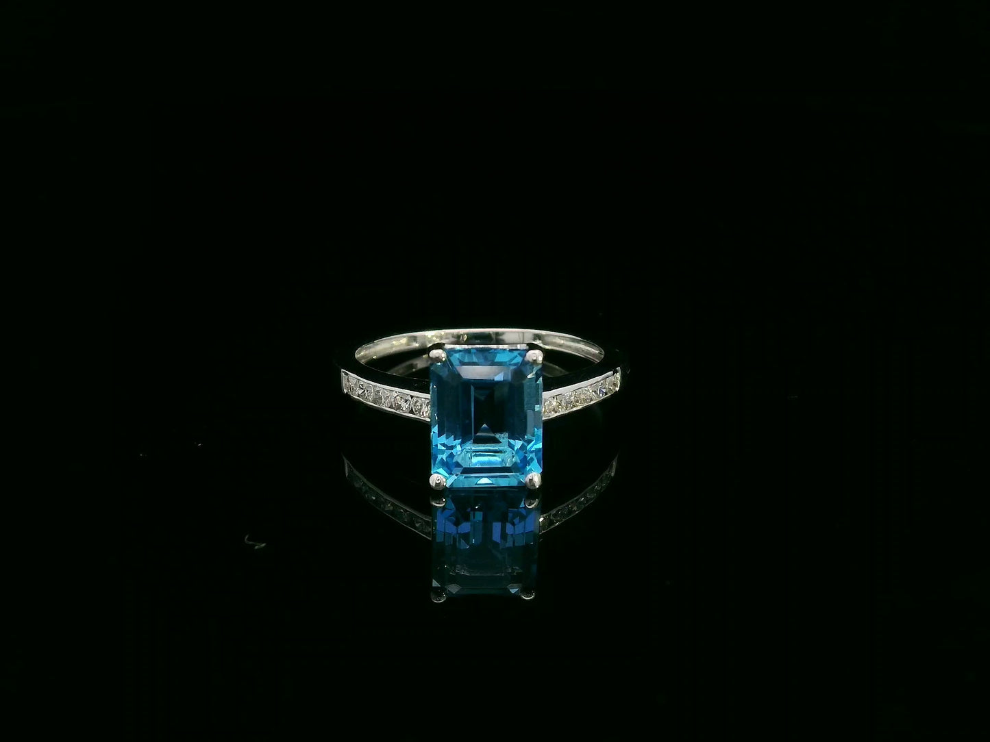 Swiss blue topaz emerald cut ring with diamond band in 18K white gold by Emirates Diamonds