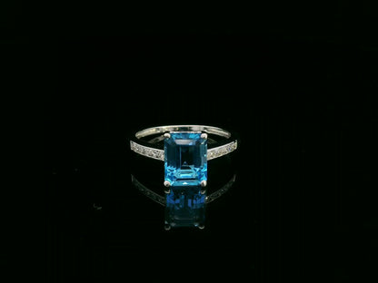 Swiss blue topaz emerald cut ring with diamond band in 18K white gold by Emirates Diamonds