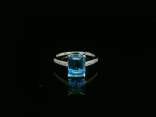 Swiss blue topaz emerald cut ring with diamond band in 18K white gold by Emirates Diamonds