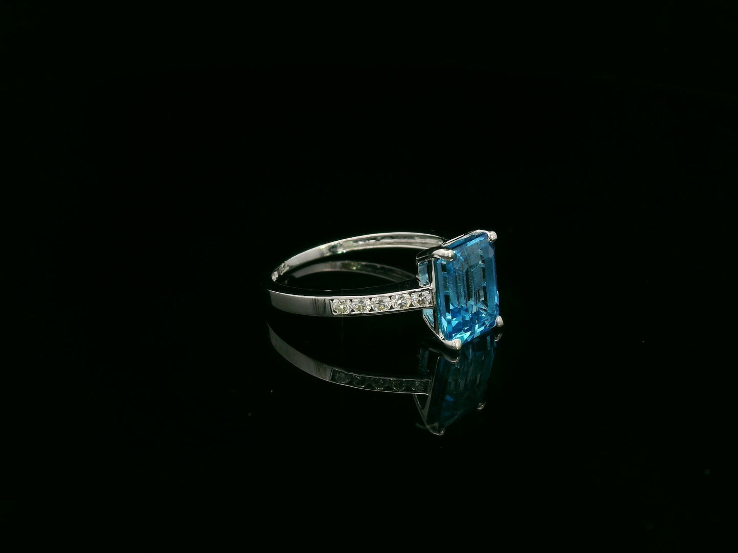 Swiss blue topaz emerald cut ring with diamond band in 18K white gold by Emirates Diamonds