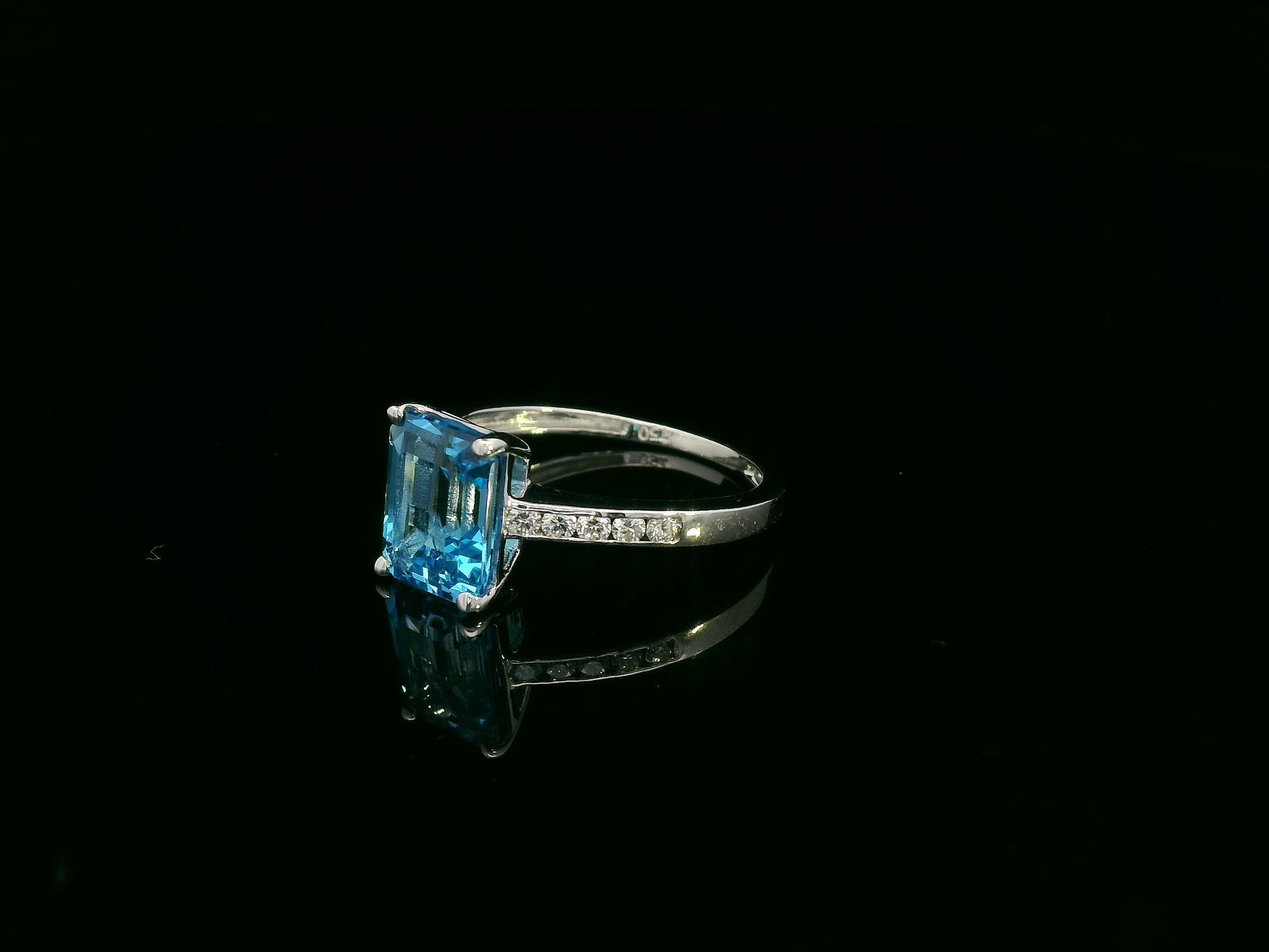 Swiss blue topaz emerald cut ring with diamond band in 18K white gold by Emirates Diamonds