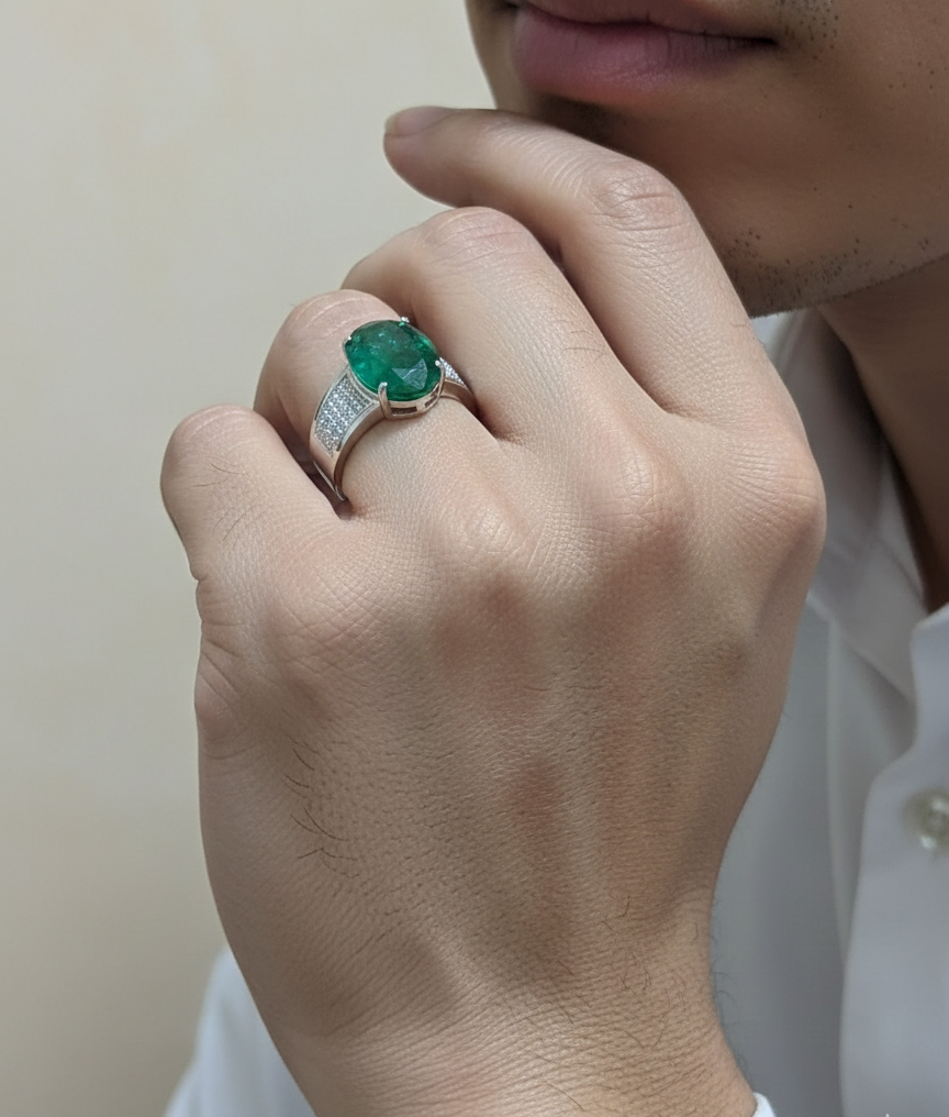 Oval emerald statement ring in 18K white gold with diamond-set shoulders by Emirates Diamonds.