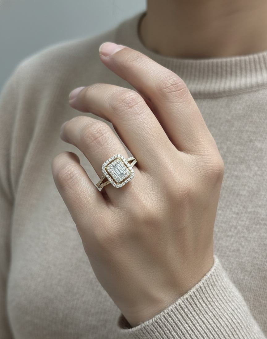 0.58 carat IGI certified emerald cut diamond halo ring in 18K yellow gold with 0.56 carat pavé diamonds by Emirates Diamonds.