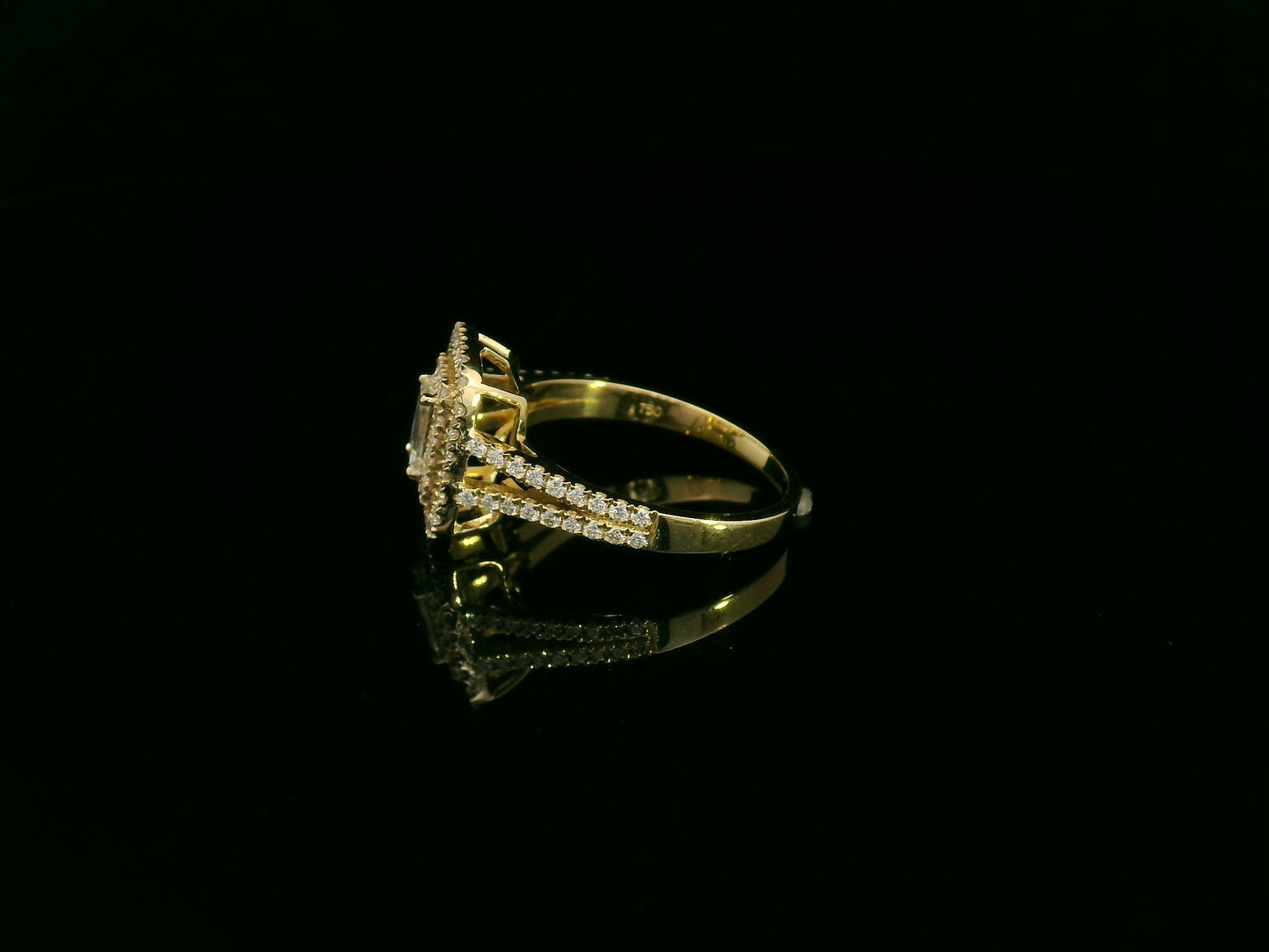 0.58 carat IGI certified emerald cut diamond halo ring in 18K yellow gold with 0.56 carat pavé diamonds by Emirates Diamonds.